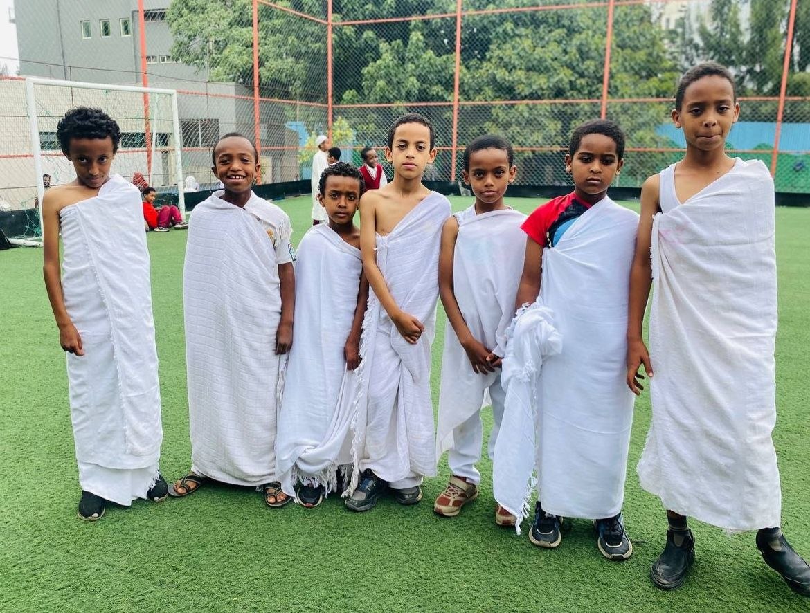 Students dressed in white ihram-style garments for Arafah Day