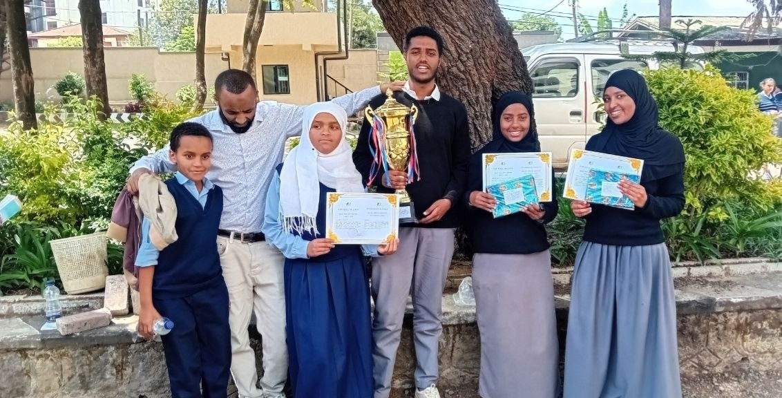 Mina Yisak with trophy and certificates after winning the Lideta Sub-City Grade 8 Q&A Competition