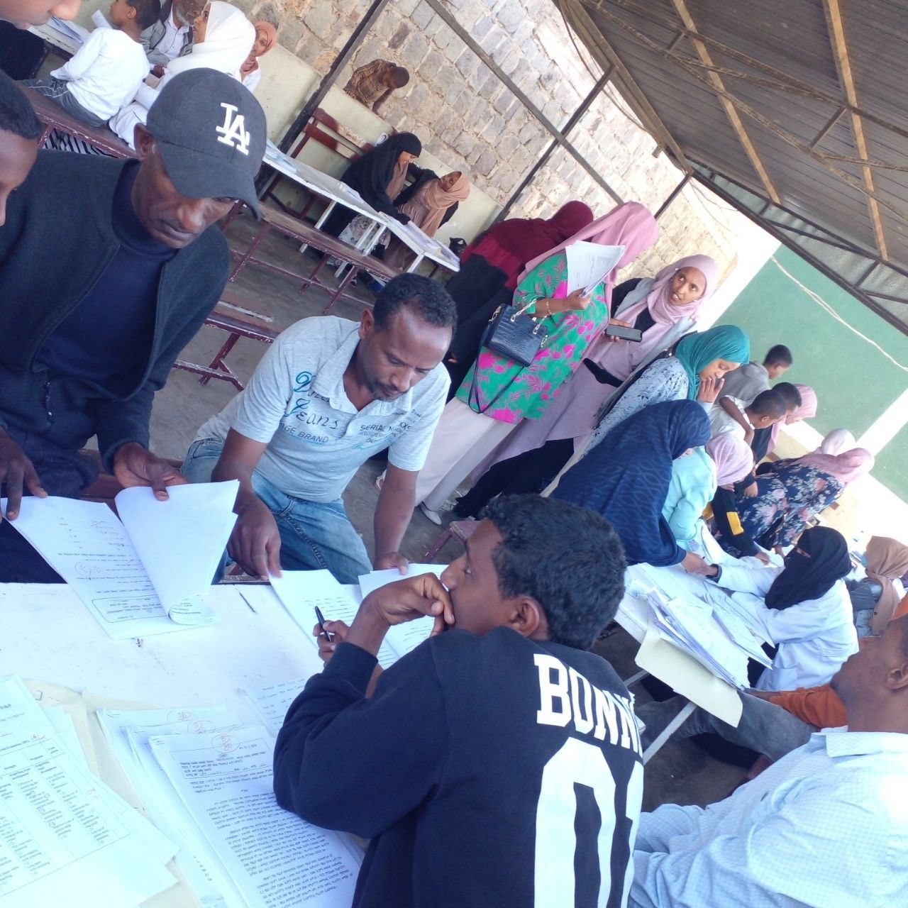 Parents reviewing academic documents with teachers during the conference